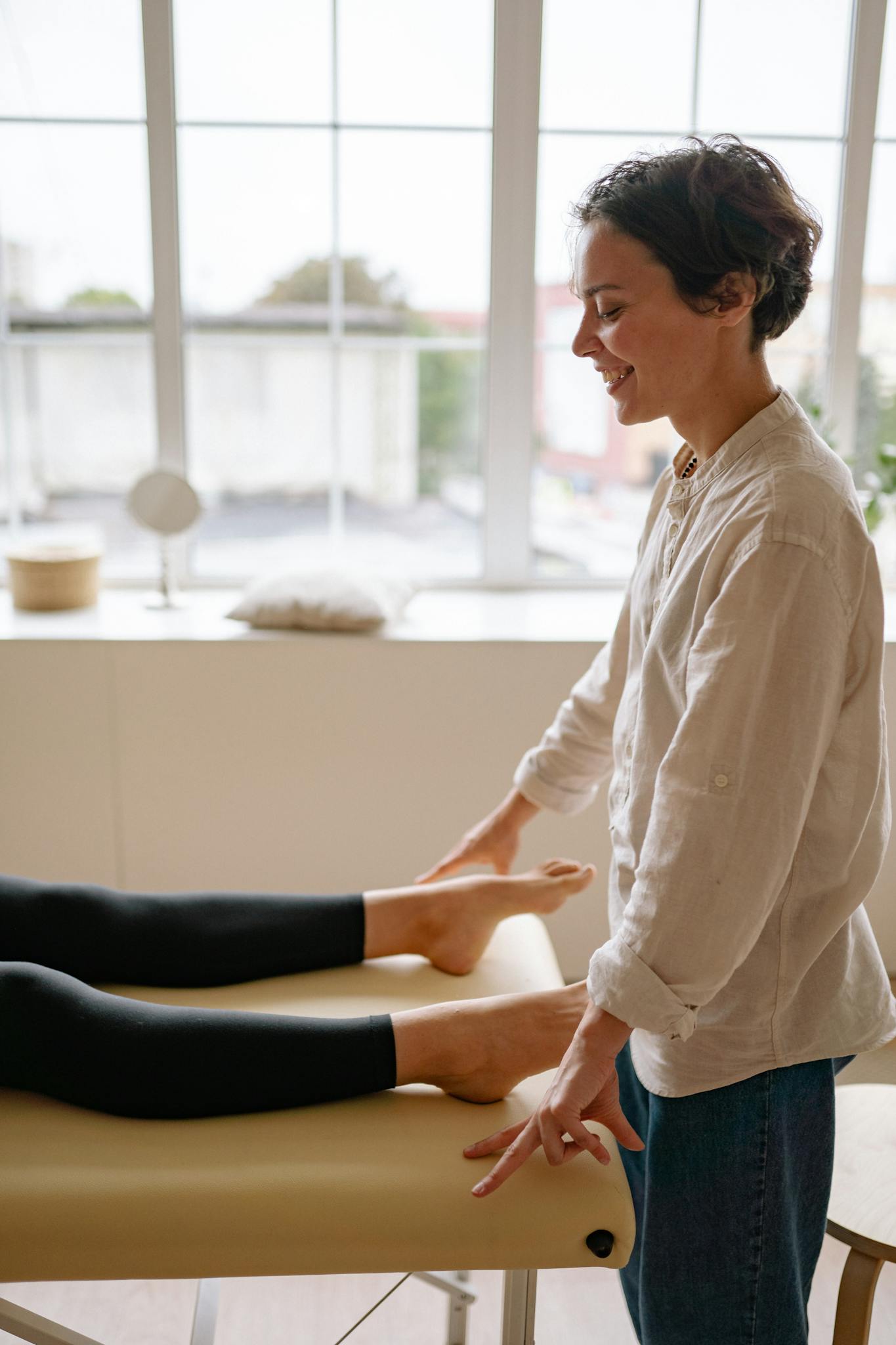 Therapist providing a soothing massage therapy session indoors.